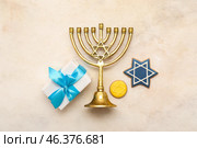 Composition for Hanukkah celebration with menorah, gift box and cookies on white grunge background. Стоковое фото, фотограф Pixel_shot / Фотобанк Лори