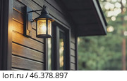 Outdoor Lantern on a Rustic Wooden Wall of Cottage Facade. Vintage iron lantern. Exterior design elements. Classic lamp. Decorative architecture objects of evening lighting with warm glow, copy space. Стоковое AI-видео, аниматор Марина Демидюк / Фотобанк Лори