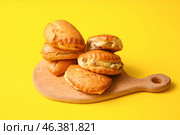 Wooden board of tasty sochniki with cottage cheese on yellow background. Стоковое фото, фотограф Pixel_shot / Фотобанк Лори