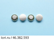 Lithium button cell batteries on blue background. Стоковое фото, фотограф Pixel_shot / Фотобанк Лори