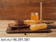 Kitchen board with sweet honey, combs and beebread on wooden background. Стоковое фото, фотограф Pixel_shot / Фотобанк Лори