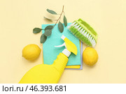 Composition with detergent, dusters, lemons and cleaning brush on color background. Стоковое фото, фотограф Pixel_shot / Фотобанк Лори