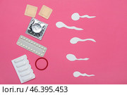 Different contraceptives and spermatozoa made of paper on color background. Safe sex concept. Стоковое фото, фотограф Pixel_shot / Фотобанк Лори