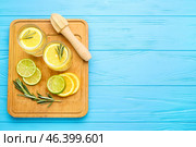Glasses of healthy lemonade and squeezer on color wooden background. Стоковое фото, фотограф Pixel_shot / Фотобанк Лори