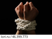 Female hostage with tied hands on dark background, closeup. Стоковое фото, фотограф Pixel_shot / Фотобанк Лори