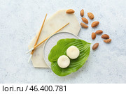 Tasty Japanese mochi and nuts on grey background. Стоковое фото, фотограф Pixel_shot / Фотобанк Лори