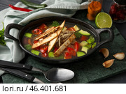Baking dish with tasty Sopa de Lima soup on table. Стоковое фото, фотограф Pixel_shot / Фотобанк Лори