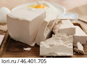 Wooden board with fresh yeast briquettes on table. Стоковое фото, фотограф Pixel_shot / Фотобанк Лори