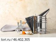 Beekeeping supplies and honey on table. Стоковое фото, фотограф Pixel_shot / Фотобанк Лори