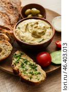 Bowl with tasty baba ghanoush, bread and vegetables on wooden background, closeup. Стоковое фото, фотограф Pixel_shot / Фотобанк Лори