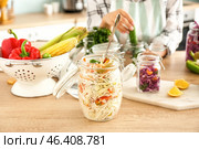 Jar with grated cabbage prepared for fermentation on table. Стоковое фото, фотограф Pixel_shot / Фотобанк Лори