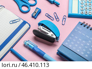 Stapler with different stationery supplies on pink background. Стоковое фото, фотограф Pixel_shot / Фотобанк Лори