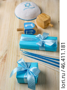 Gifts with candles and dreidels for Hannukah celebration on wooden background, closeup. Стоковое фото, фотограф Pixel_shot / Фотобанк Лори