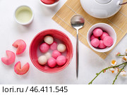 Bowls of tasty tangyuan and cookies on white background. Dongzhi Festival. Стоковое фото, фотограф Pixel_shot / Фотобанк Лори