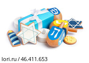 Gift with candles and cookies for Hannukah celebration on white background. Стоковое фото, фотограф Pixel_shot / Фотобанк Лори