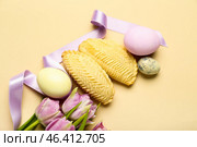 Tulips with eggs and shekarbura on beige background. Novruz Bayram celebration. Стоковое фото, фотограф Pixel_shot / Фотобанк Лори