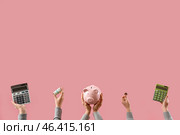 Women with money, piggy bank and calculators on pink background. Стоковое фото, фотограф Pixel_shot / Фотобанк Лори
