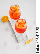 Glasses of Aperol spritz cocktail on light background. Стоковое фото, фотограф Pixel_shot / Фотобанк Лори