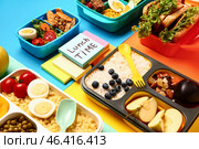 Different tasty food in lunchboxes and sticky notes with text LUNCH TIME on color background. Стоковое фото, фотограф Pixel_shot / Фотобанк Лори