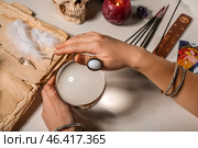 Soothsayer with crystal ball and magic attributes at table. Стоковое фото, фотограф Pixel_shot / Фотобанк Лори