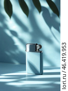 Sleek lighter in soft blue light casting intriguing shadows on a surface surrounded by leaves. Стоковое AI-изображение, AI-художник Сергей Толмачёв / Фотобанк Лори