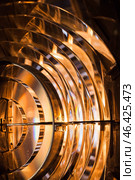 Illuminated Fresnel lens, showcasing its intricate glass structure. Стоковое фото, фотограф EugeneSergeev / Фотобанк Лори