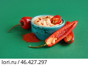 Bowl of tasty chipotle sauce and fresh jalapeno peppers on color background. Стоковое фото, фотограф Pixel_shot / Фотобанк Лори
