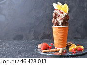 Cup with delicious sweet bubble waffle on dark background. Стоковое фото, фотограф Pixel_shot / Фотобанк Лори