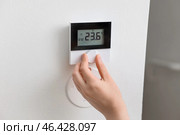 Woman adjusting air conditioner in room, closeup. Стоковое фото, фотограф Pixel_shot / Фотобанк Лори