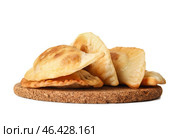 Cork stand with tasty meat empanadas on white background. Стоковое фото, фотограф Pixel_shot / Фотобанк Лори