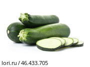 Fresh zucchini squashes with pieces on white background. Стоковое фото, фотограф Pixel_shot / Фотобанк Лори