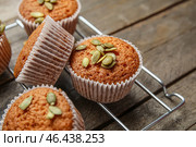 Стеллаж для охлаждения с вкусными тыквенными маффинами на столе, крупным планом. Стоковое фото, фотограф Pixel_shot / Фотобанк Лори