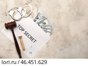 Судейский молоток, бумага с текстом «Совершенно секретно», печать, деньги и наручники на сером фоне. Стоковое фото, фотограф Pixel_shot / Фотобанк Лори