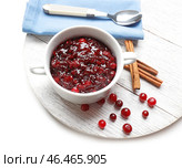 Чаша с вкусным клюквенным соусом и палочками корицы на деревянной доске. Стоковое фото, фотограф Pixel_shot / Фотобанк Лори