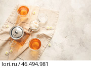 Чайник с горячим чаем, стаканы и кубики сахара на светлом фоне. Стоковое фото, фотограф Pixel_shot / Фотобанк Лори