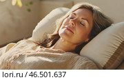 Mature woman relaxing on comfortable couch. Стоковое AI-видео, аниматор Юрий Поздников / Фотобанк Лори
