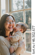 Mother and baby sharing a joyful moment by the window. Стоковое AI-видео, аниматор Юрий Поздников / Фотобанк Лори