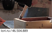 Applying wood stain to a handcrafted wooden box for a rustic finish. Стоковое видео, видеограф PAv / Фотобанк Лори