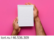 Мужчина держит пустую фоторамку на розовом фоне. Стоковое фото, фотограф Pixel_shot / Фотобанк Лори