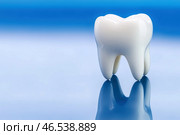 Dental implant, toothache concept on blue background. Стоковое AI-изображение, AI-художник Станислав Тарко / Фотобанк Лори