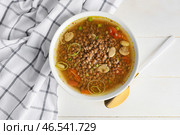 Тарелка вкусного чечевичного супа на столе. Стоковое фото, фотограф Pixel_shot / Фотобанк Лори