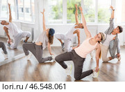 Girl and her students perform hip hop dance on one bent leg, movement in horizontal plane near floor. Стоковое фото, фотограф Яков Филимонов / Фотобанк Лори