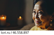 Happy, face and elderly asian woman in yellow sweater on sofa to relax at home or grandma laughing freedom in retirement. Portrait, elderly smile living room, home or thinking about good memory. Стоковое видео, видеограф ALLA YURTAYEVA / Фотобанк Лори