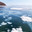 Unusual winter landscape of frozen Lake Baikal on cold winter day. Texture of transparent blue ice with white layered bubbles of bottom gases. Natural background. Winter travel and outdoor recreation. Стоковое фото, фотограф Виктория Катьянова / Фотобанк Лори