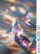 Colorful light refracting through crystal prisms on a textured surface in soft morning light. Стоковое AI-изображение, AI-художник Сергей Толмачёв / Фотобанк Лори
