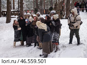 Sestroretsk, Russia - February 19, 2023: In a snowy forest, civilians express despair while soldiers stand guard, reflecting the tension of winter battles during the Second World War. Редакционное фото, фотограф Aleksandr Golubev / Фотобанк Лори