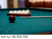 Russian billiards. Red and white balls are lying on a green billiard table. Spending time at home playing a hobby sports game. Стоковое фото, фотограф Photojuli / Фотобанк Лори