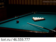Russian billiards. Red and white balls are lying on a green billiard table. Spending time at home playing a hobby sports game. Стоковое фото, фотограф Photojuli / Фотобанк Лори