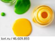 Bright colored nail polish bottles with drippings on white background. Стоковое фото, фотограф Сергей Толмачёв / Фотобанк Лори