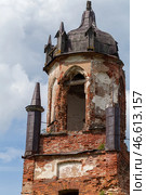 A weathered brick bell tower with gothic architectural details. Стоковое фото, фотограф EugeneSergeev / Фотобанк Лори
